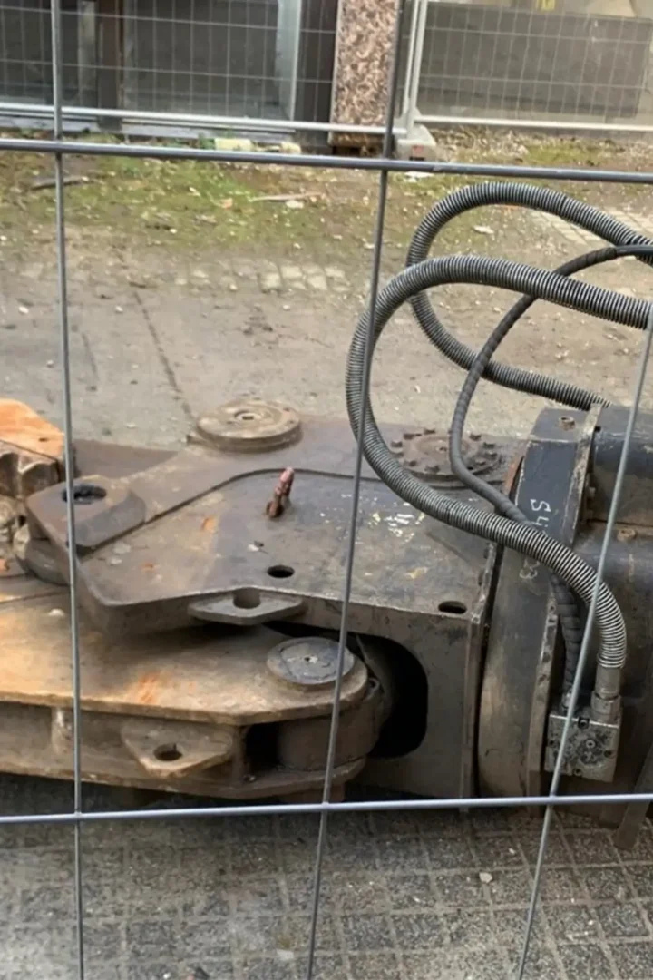 Baugerät hinter Bauzaun